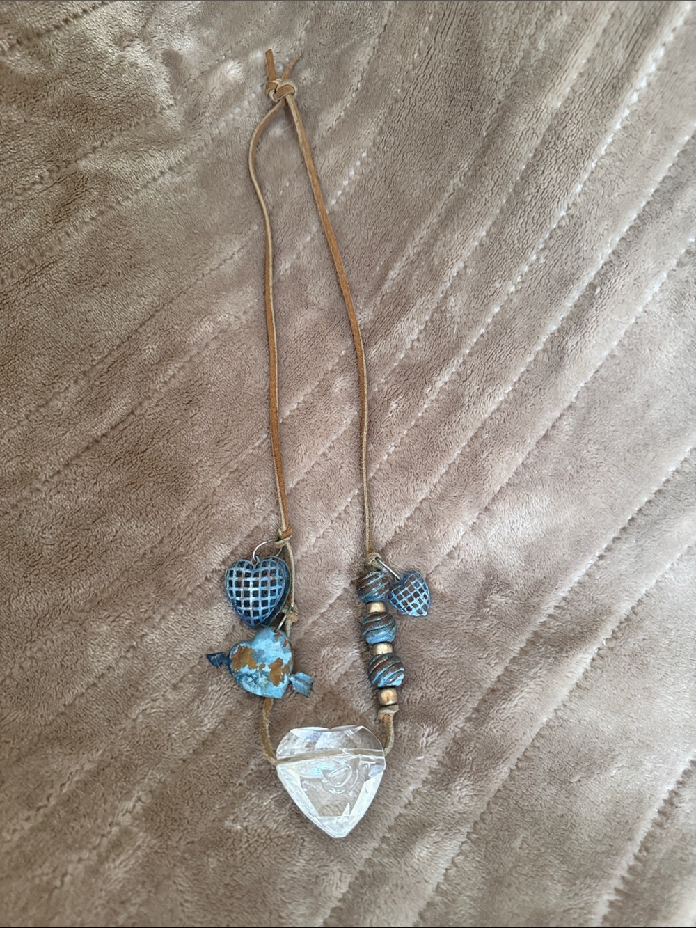 Source Unknown Blue Patina and Gold Heart Charm Necklace with rawhide necklace.